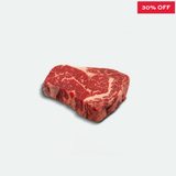 Steak with a 30% off label on a light gray background
